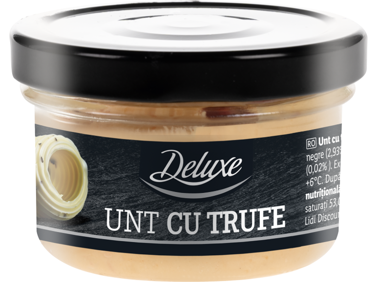 Borcan de unt cu trufe cu etichetă neagră și o spirală de unt în stânga