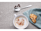 Cappuccino cu scorțișoară, boabe de cafea, lingură și biscotti cu migdale pe pânză de in.