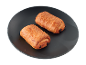 Două croissante aurii cu ciocolată pe o farfurie închisă.