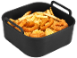 Coș de friteuză cu aer umplut cu cartofi prăjiți aurii, inele de ceapă și bucăți de pui pane.