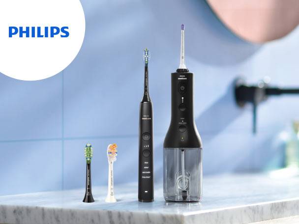 Periuță de dinți electrică și irigator bucal negre, cu capete de periuță de rezervă, pe o chiuvetă de baie.