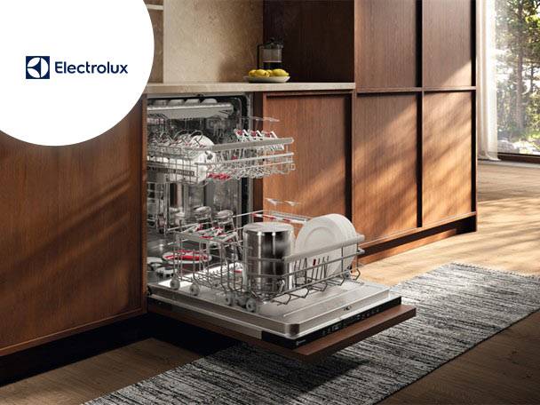 O mașină de spălat vase deschisă, plină cu vase curate, într-o bucătărie modernă.