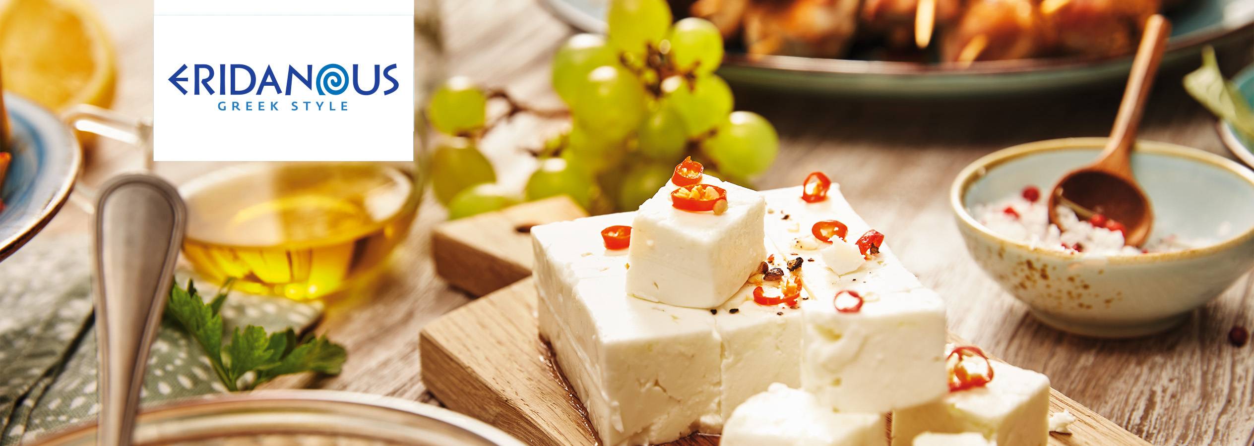 Brânză feta Eridanus Greek Style, cu ardei iute, servită cu măsline și struguri.