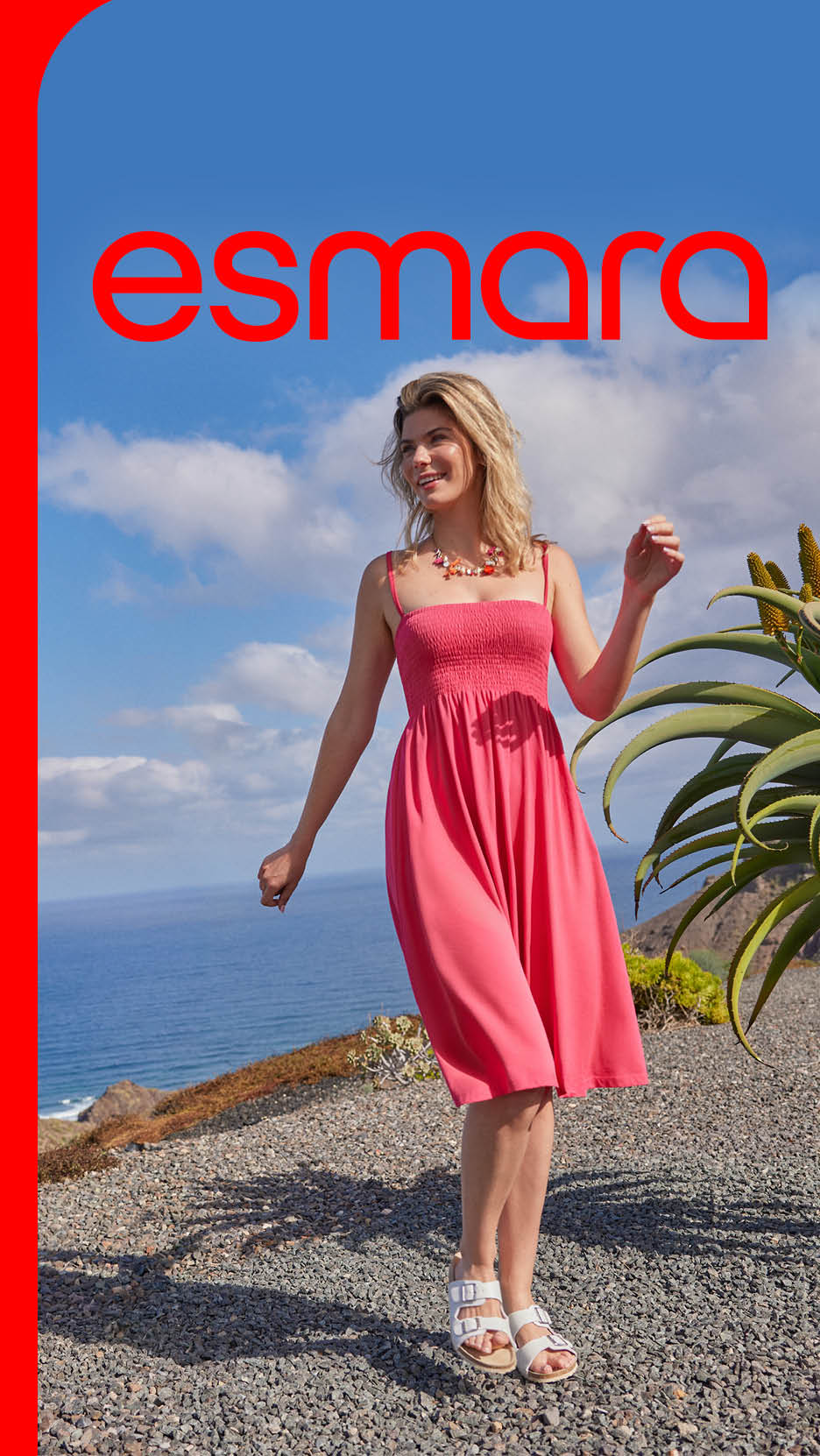 Femeie zâmbitoare în rochie roz și sandale albe, pe un deal cu vedere la mare. Text: esmara.