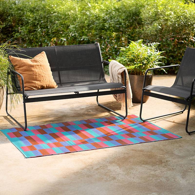 Mobilier de grădină și covor geometric.